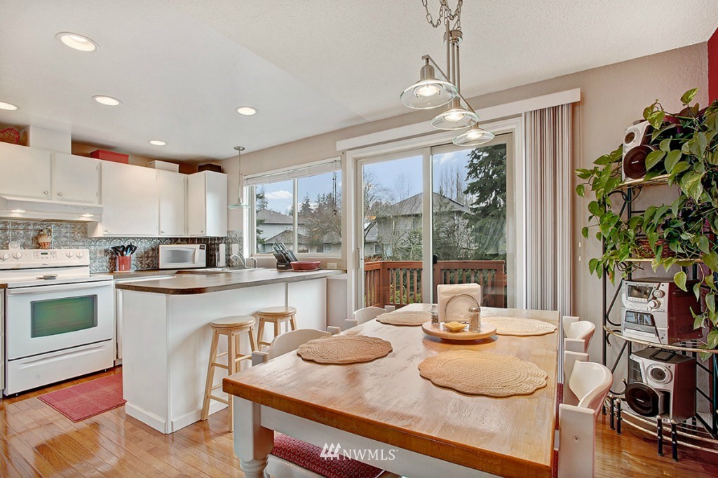 611 204th Street Southeast Bothell, WA 98012 - Photo 5 of 24 a kitchen with sink a table and chairs
