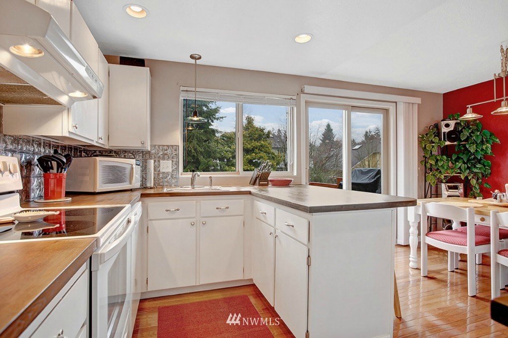 611 204th Street Southeast Bothell, WA 98012 - Photo 6 of 24 a kitchen with a sink stove and cabinets