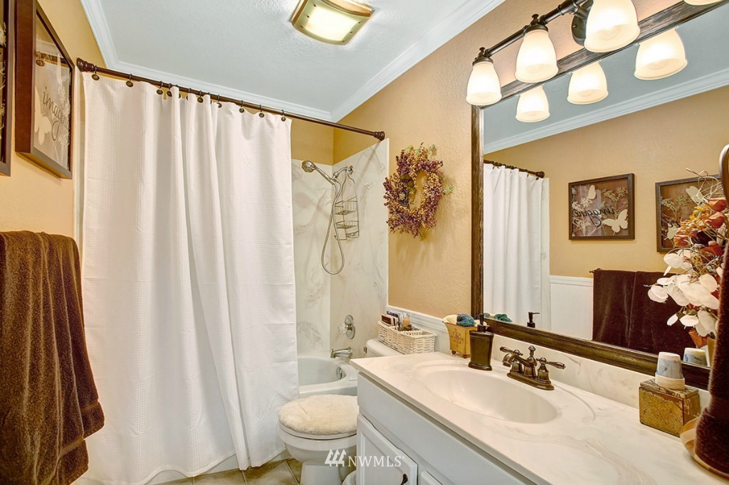 611 204th Street Southeast Bothell, WA 98012 - Photo 9 of 24 a bathroom with a sink a toilet and shower curtain