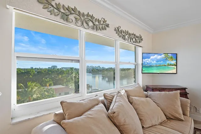 a bedroom with furniture and large window