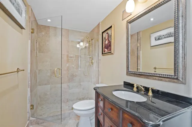 a bathroom with a sink a toilet and shower