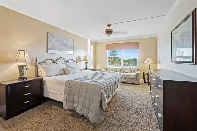 a bedroom with a bed and a painting on the wall