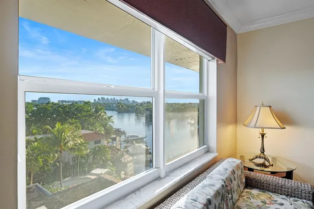 a living room with a large window and a table