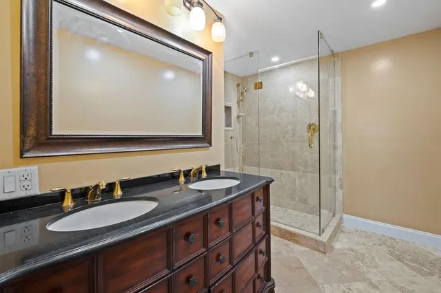 a bathroom with a granite countertop sink mirror and double
