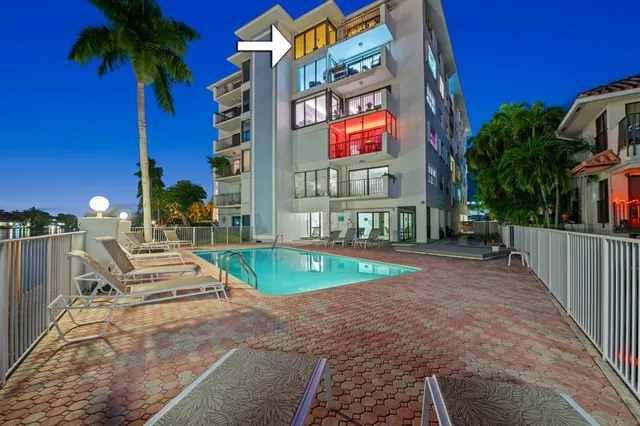 a view of a street with potted plants