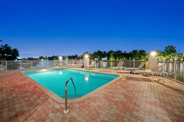a view of a swimming pool an outdoor seating