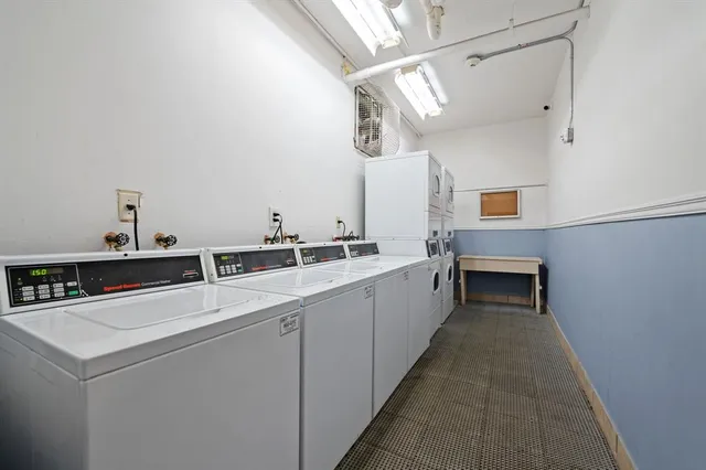 a large white kitchen with cabinets