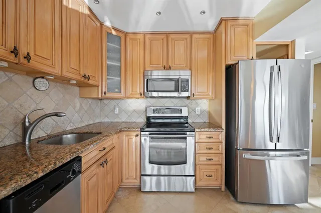 a kitchen with a refrigerator sink and stove