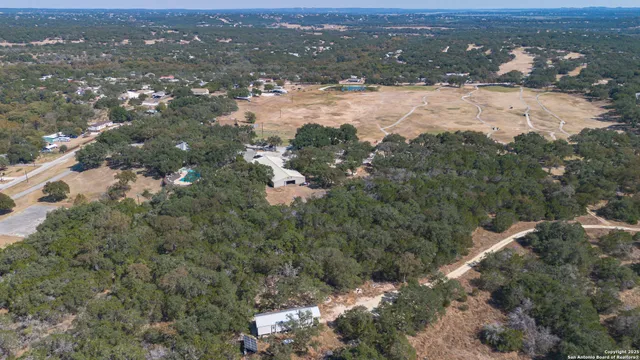 an aerial view of houses with yard