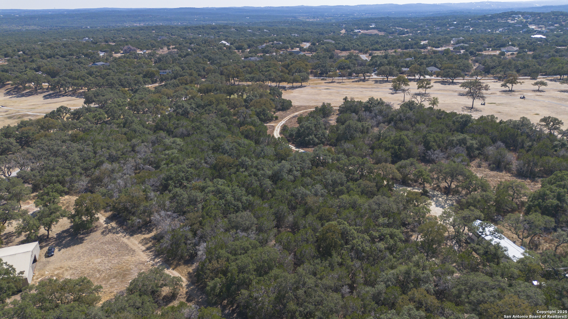 154 Fore Drive Spring Branch, TX 78070 - Photo 5 of 12 an aerial view of houses with yard and mountain view in back