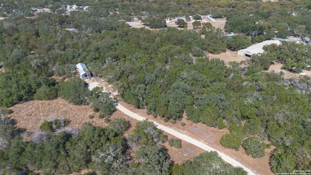 a aerial view of a house with a yard and mountain