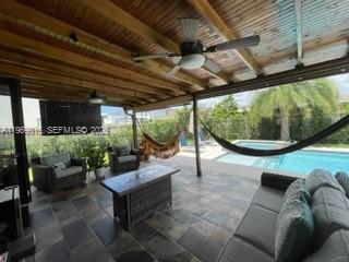 27844 Southwest 133rd Path Homestead, FL 33032 - Photo 15 of 19 a living room with patio furniture and a potted plant