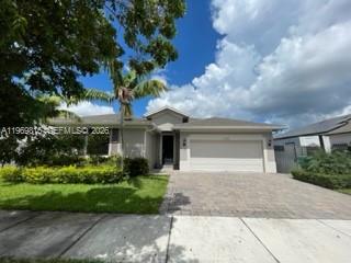 27844 Southwest 133rd Path Homestead, FL 33032 - Photo 19 of 19 a front view of a house with garden