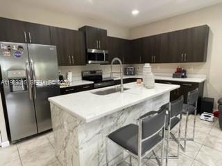 27844 Southwest 133rd Path Homestead, FL 33032 - Photo 7 of 19 a kitchen with stainless steel appliances a sink a stove a refrigerator and cabinets