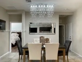 a view of a dining room with furniture and chandelier