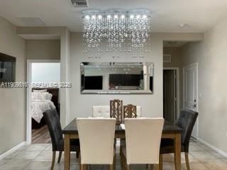 27844 Southwest 133rd Path Homestead, FL 33032 - Photo 9 of 19 a view of a dining room with furniture and chandelier