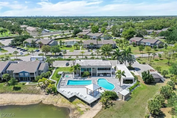 an aerial view of a house with a swimming pool outdoor seating and yard