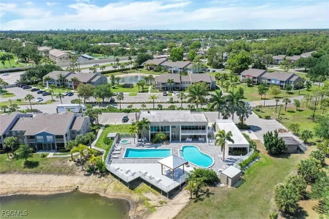 an aerial view of a house with a swimming pool outdoor seating and yard