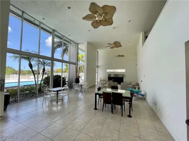 a work room with a large window and furniture