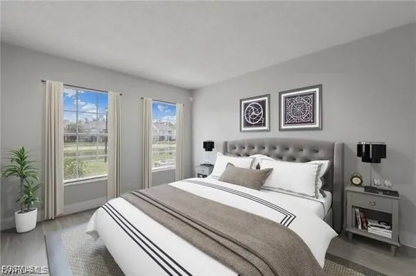 a bedroom with a large bed and a potted plant