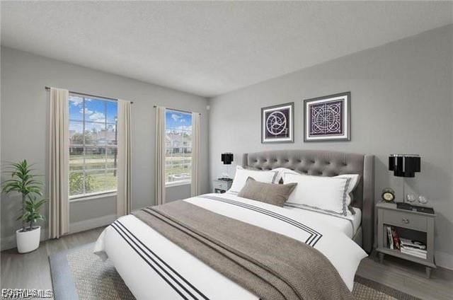 161 Santa Clara Drive, Unit 57S Naples, FL 34104 - Photo 2 of 23 a bedroom with a large bed and a potted plant