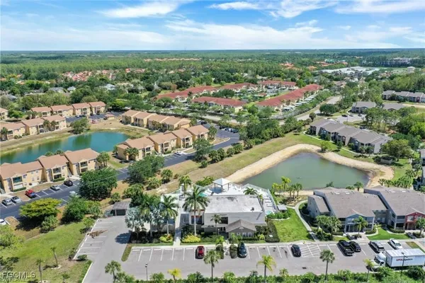 an aerial view of a city with lots of residential buildings lake and ocean view