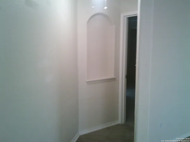 a view of staircase with white walls and stairs