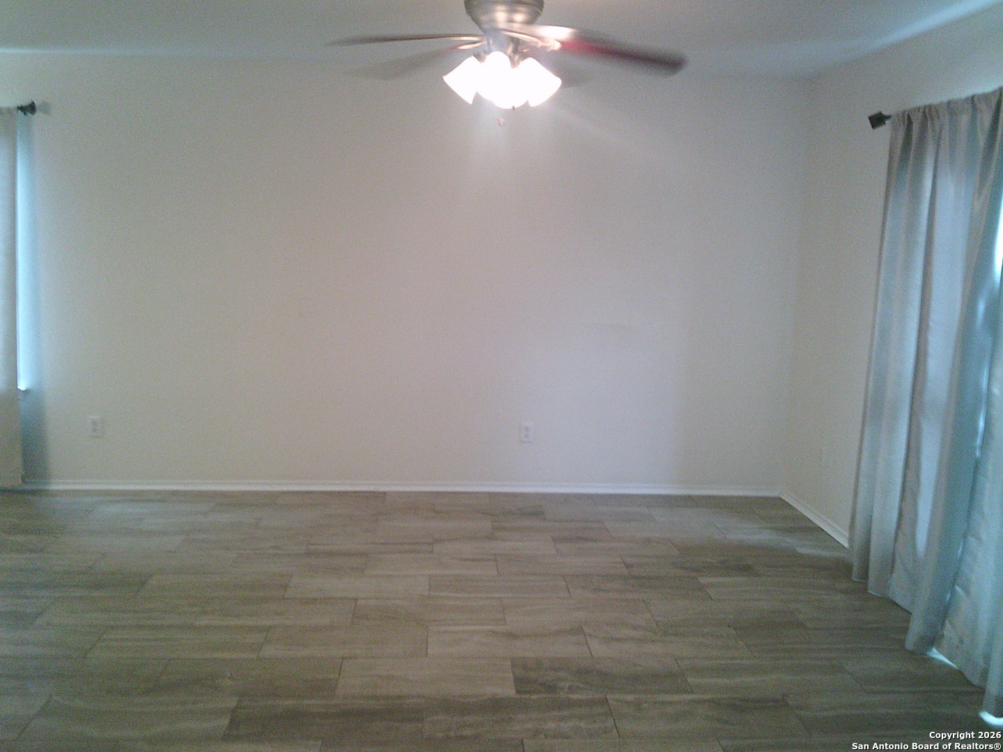 3834 Hatwig Converse, TX 78109 - Photo 4 of 33 a view of an empty room with wooden floor and a window