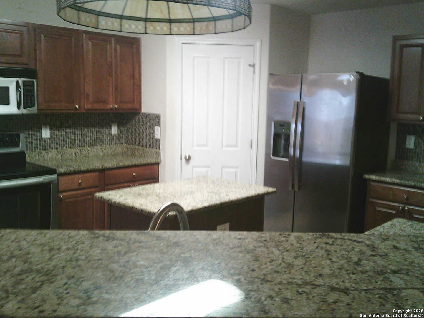 3834 Hatwig Converse, TX 78109 - Photo 10 of 33 a kitchen with granite countertop a refrigerator and a sink