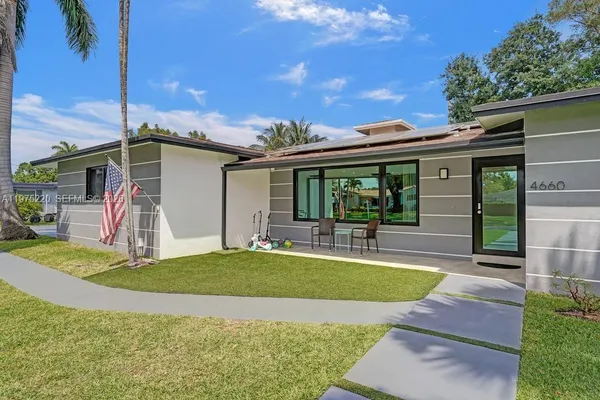 a view of a house with backyard porch and sitting area