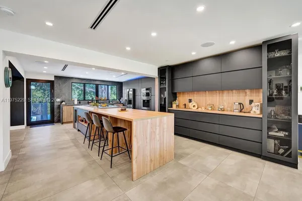 a view of a dining room with furniture and a floor to ceiling window