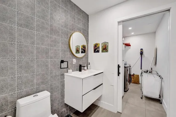 a bedroom with a bed and a view of kitchen