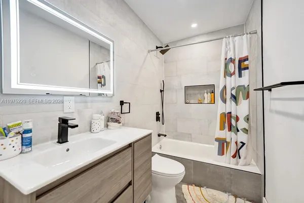 a view of a livingroom with furniture and a window