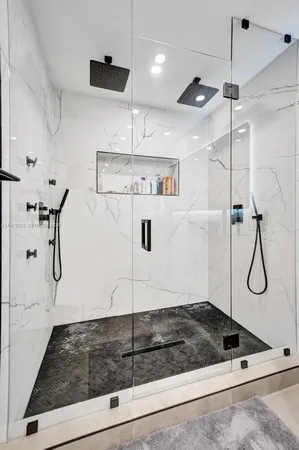 a spacious bedroom with a bed and a workspace