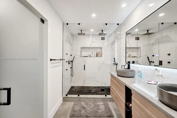 a living room with furniture and a book shelf