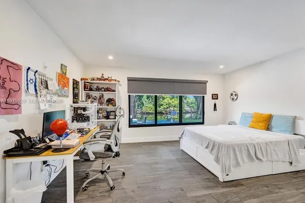 a view of a patio with table and chairs with wooden floor and fence