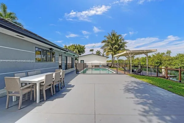 a view of a backyard with plants and a patio