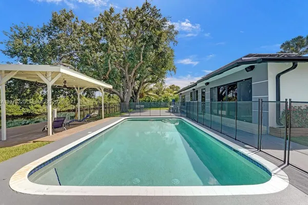 a view of a house with a yard and a garage