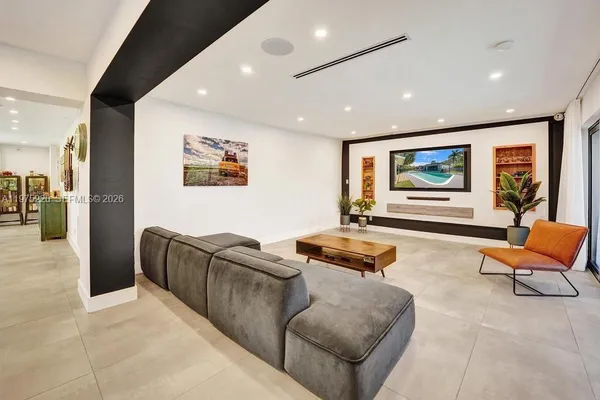 a large kitchen with stainless steel appliances granite countertop a large counter top a stove a sink and a refrigerator