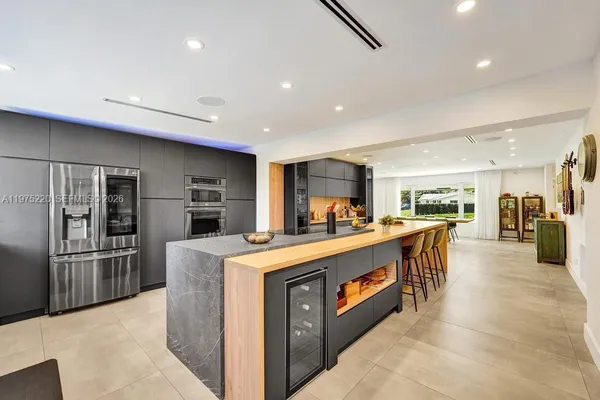 a kitchen with stainless steel appliances granite countertop a refrigerator and stove