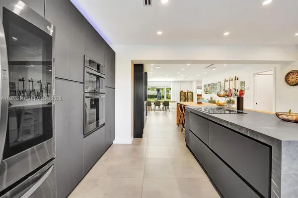 a kitchen with stainless steel appliances granite countertop a stove and a sink