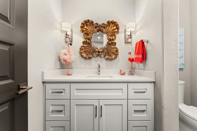 a bathroom with a sink vanity and a mirror