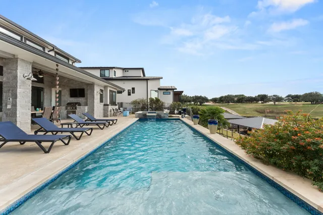 a view of a house with sitting area and garden