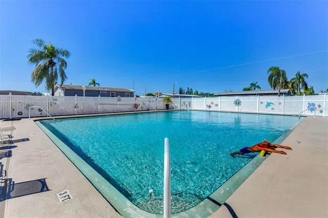 a view of a swimming pool with a yard