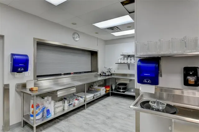 a kitchen with stainless steel appliances granite countertop a stove and cabinets