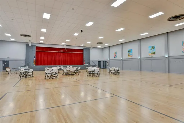 a view of a room with lots of tables and chairs