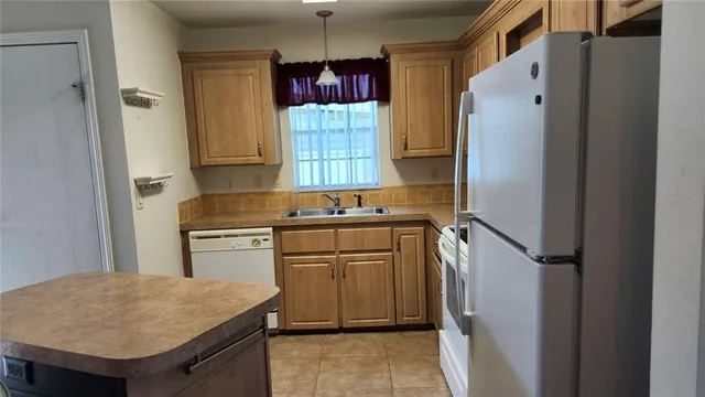 a kitchen with stainless steel appliances granite countertop a refrigerator and a stove