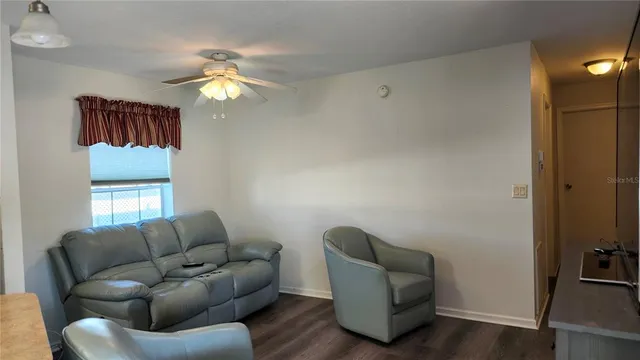 a living room with furniture and a lamp