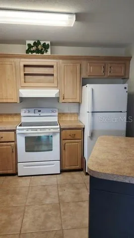 a kitchen with a stove and white cabinets