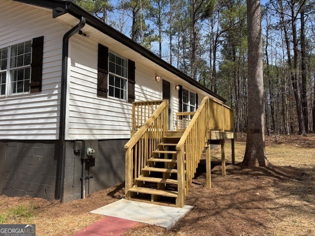 2211 Newborn Road Rutledge, GA 30663 - Photo 1 of 1 a front view of a house with stairs and wooden fence
